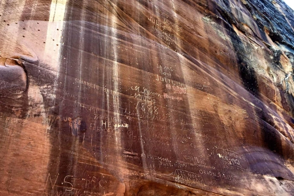 Ancient petroglyphs carved into the sandstone walls of Capitol Gorge