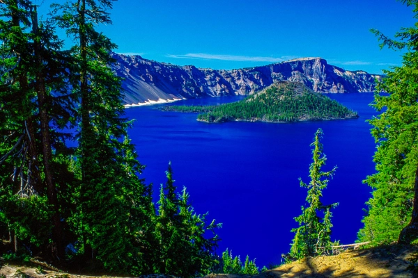 Wizard Island rising from the deep blue water of Crater Lake
