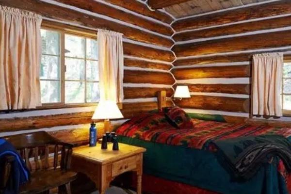 A cozy cabin nestled in the woods at Colter Bay Village
