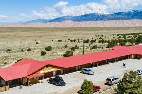 The Great Sand Dunes Lodge with a view of the dunes from a guest room