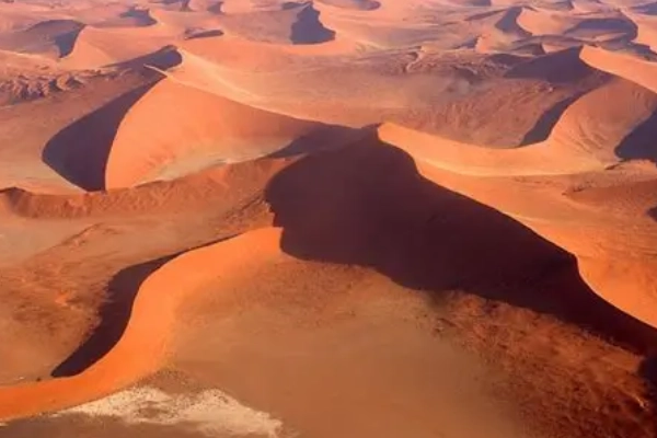 A hiker on the summit of Star Dune, the tallest dune in North America