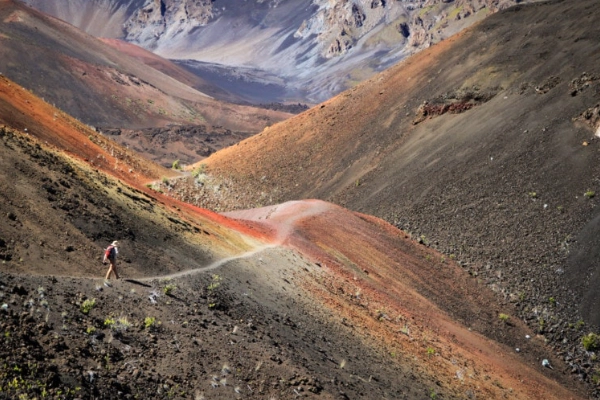 A hiker on the Mars-like landscape of the Sliding Sands Trail inside the crater