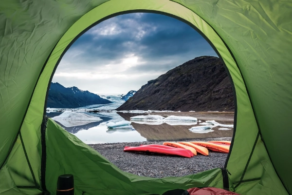 A tent set up on a remote beach for kayak-camping