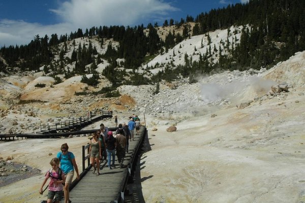 A boardwalk winding through the steaming vents and mud pots of Bumpass Hell