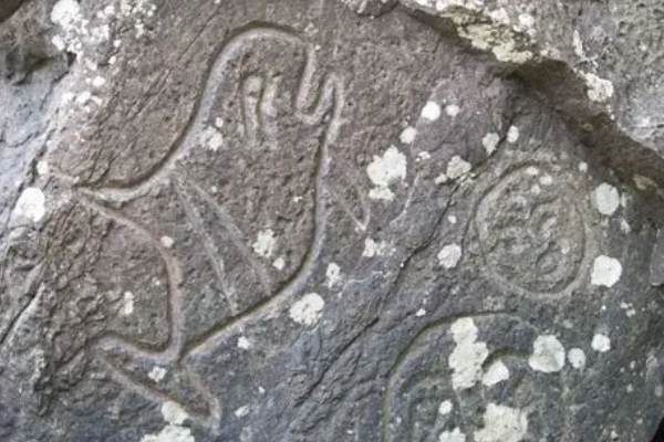 Ancient petroglyphs of whales and spirits carved into stone