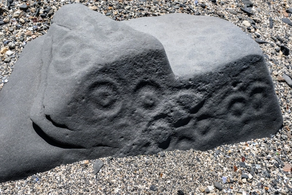 Ancient Athabascan carvings of caribou and spirits on a rock face
