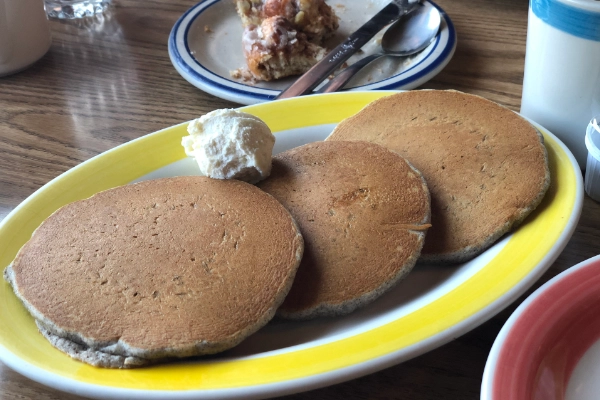 A stack of pancakes topped with huckleberries
