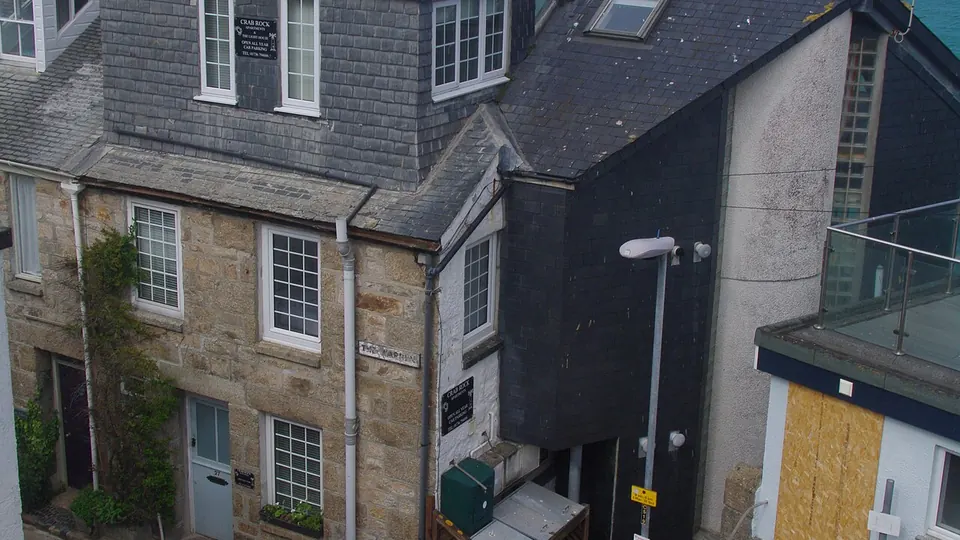 St Ives, Cornwall destination photo: Crab Rock apartments and the harbour, The Warren, St Ives, Cornwall - April 2021